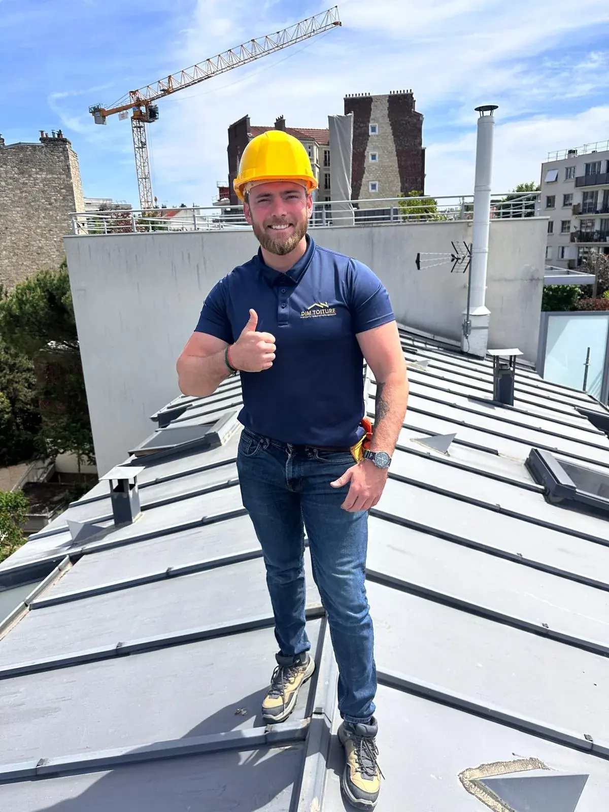 Bryan Dim, maître couvreur et dirigeant de Dim Toiture, sur une toiture en zinc à joint debout