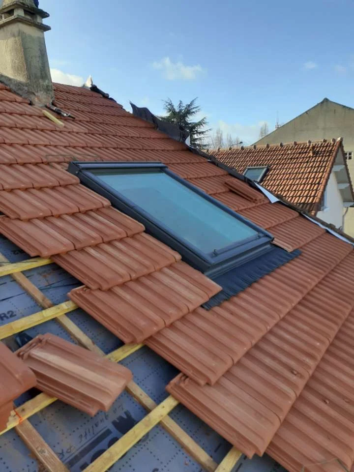 Fenêtre de toit posée et raccordée sur une couverture en tuiles neuve, chantier Dim Toiture